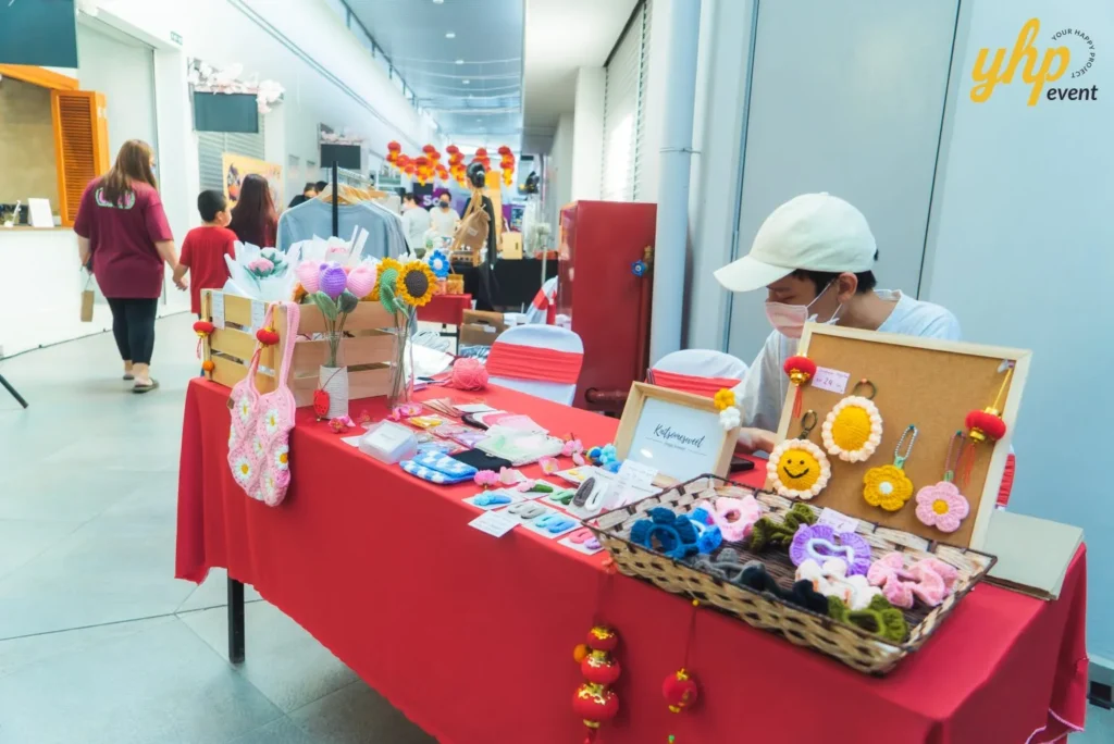 #TooHuattoHandle Lunar New Year Celebration 11 Local Sabahan Crochet flowers, accessories, and handmade crafts displayed on a red table at an indoor artisan market stall