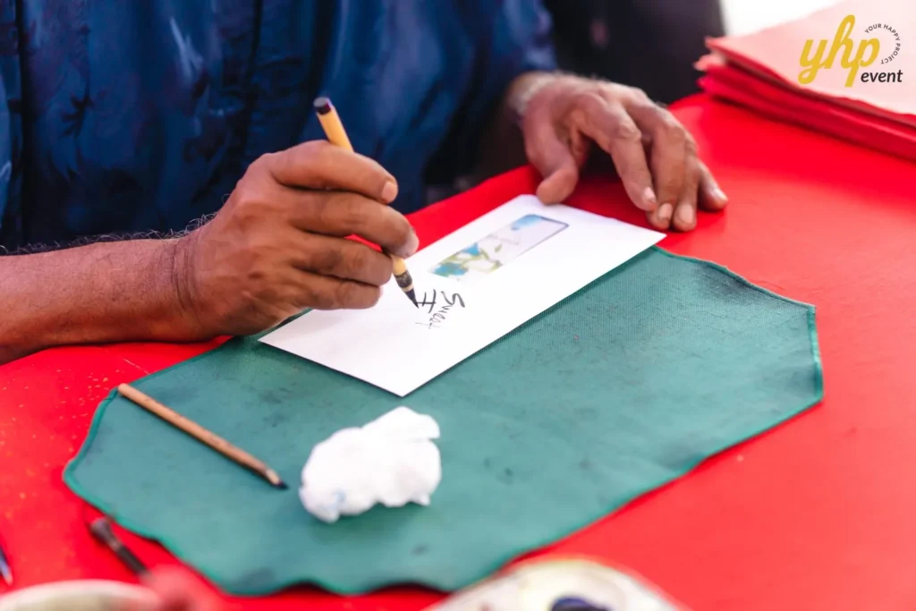 #TooHuattoHandle Lunar New Year Celebration 18 Hands writing calligraphy on a red-covered table beside ink tools and paper