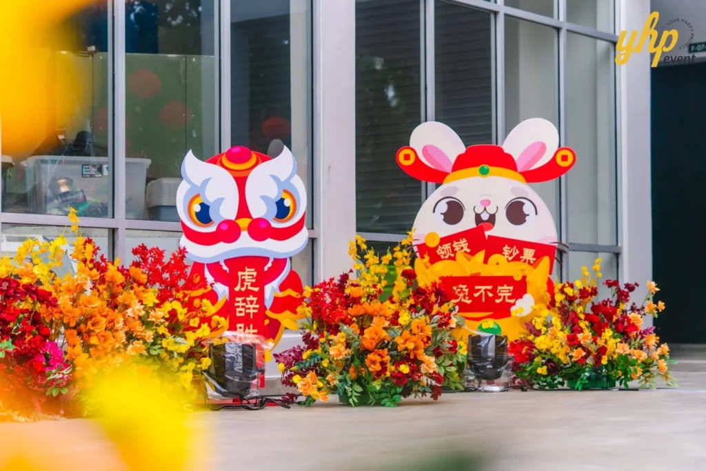 #TooHuattoHandle Lunar New Year Celebration 23 Decorative festival cutouts of a rabbit mascot and lion dance figure set among bright floral arrangements in Bukit Bantayan Residence.