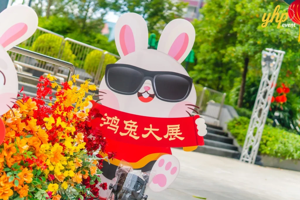 #TooHuattoHandle Lunar New Year Celebration 24 Playful rabbit display holding a red banner among autumn-toned flowers at a community celebration at Bukit Bantayan Residence.