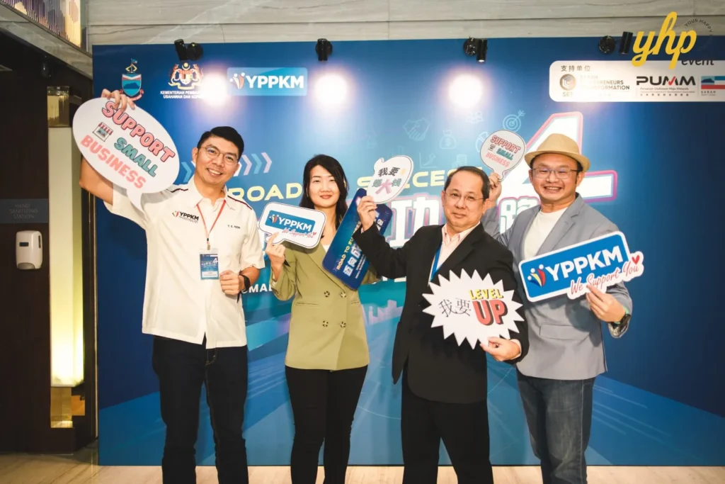 Empowering Entrepreneurs: YPPKM Small Business Seminar in Kota Kinabalu 4 Participants hold fun "Support Small Business" props at the YPPKM road to success seminar event