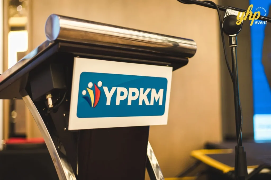 Empowering Entrepreneurs: YPPKM Small Business Seminar in Kota Kinabalu 6 Close-up of the YPPKM logo on a professional wooden lectern at a business seminar for entrepreneurs