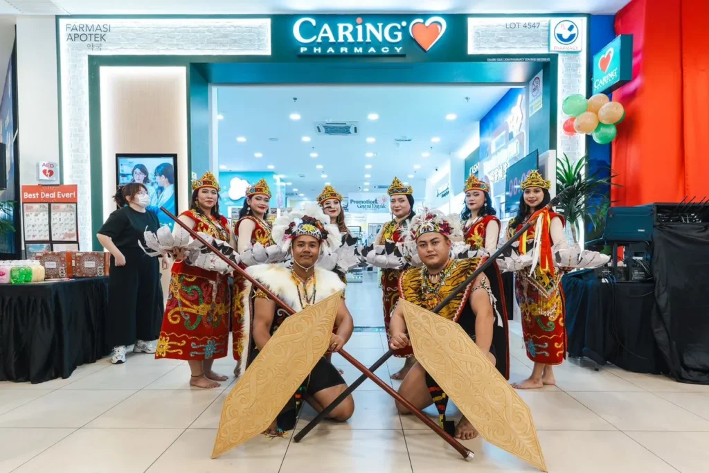 Caring Pharmacy Mural Art Unveiling Ceremony l Farley Mall , Kuching 8 Ngajat dance group photo in front of Caring Pharmacy Store